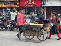 A man is pushing a cart along in the East Fort area as he sells roasted peanuts and popcorn in Thiruvananthapuram (Trivandrum), Kerala, Indi...