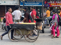 A man is pushing a cart along in the East Fort area as he sells roasted peanuts and popcorn in Thiruvananthapuram (Trivandrum), Kerala, Indi...