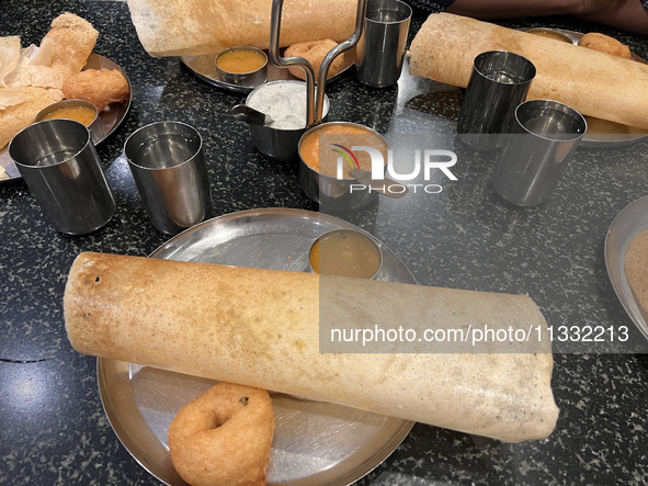 Masala dosa and vada are being served at a vegetarian restaurant in Thiruvananthapuram (Trivandrum), Kerala, India, on April 01, 2024. 