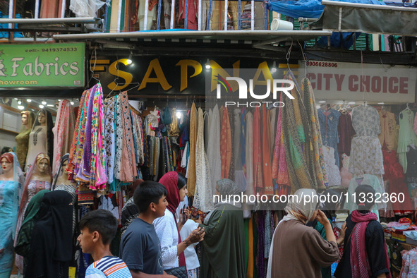 People are shopping at a market ahead of the Eid al-Adha festival in Srinagar, India, on June 15, 2024. Eid al-Adha is the holiest of the tw...