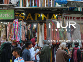 People are shopping at a market ahead of the Eid al-Adha festival in Srinagar, India, on June 15, 2024. Eid al-Adha is the holiest of the tw...