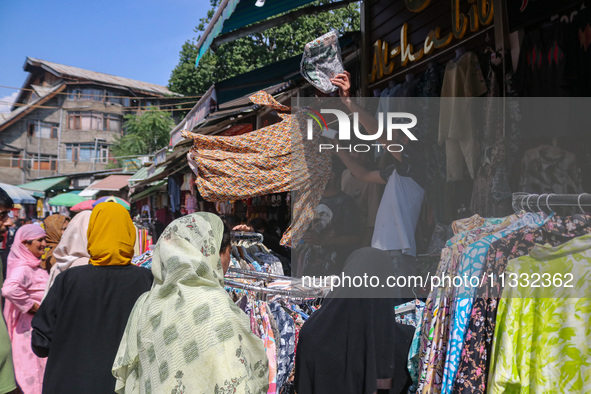 People are shopping at a market ahead of the Eid al-Adha festival in Srinagar, India, on June 15, 2024. Eid al-Adha is the holiest of the tw...