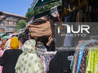 People are shopping at a market ahead of the Eid al-Adha festival in Srinagar, India, on June 15, 2024. Eid al-Adha is the holiest of the tw...