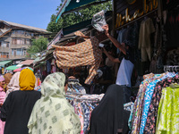 People are shopping at a market ahead of the Eid al-Adha festival in Srinagar, India, on June 15, 2024. Eid al-Adha is the holiest of the tw...