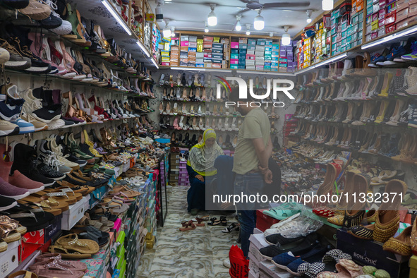 Women are shopping at a footwear store ahead of the Eid al-Adha festival in Srinagar, India, on June 15, 2024. Eid al-Adha is the holiest of...