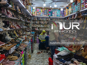 Women are shopping at a footwear store ahead of the Eid al-Adha festival in Srinagar, India, on June 15, 2024. Eid al-Adha is the holiest of...