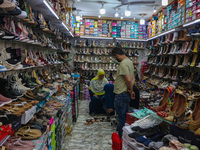 Women are shopping at a footwear store ahead of the Eid al-Adha festival in Srinagar, India, on June 15, 2024. Eid al-Adha is the holiest of...