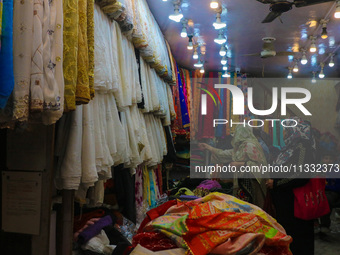 Women are shopping at a fabric store ahead of the Eid al-Adha festival in Srinagar, India, on June 15, 2024. Eid al-Adha is the holiest of t...