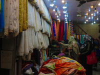 Women are shopping at a fabric store ahead of the Eid al-Adha festival in Srinagar, India, on June 15, 2024. Eid al-Adha is the holiest of t...