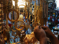 A man is arranging jewellery items at a market ahead of the Eid al-Adha festival in Srinagar, India, on June 15, 2024. Eid al-Adha is the ho...