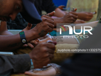 Indian artists are applying henna on the hands of Kashmiri Muslim girls ahead of the Eid al-Adha festival in Srinagar, India, on June 15, 20...