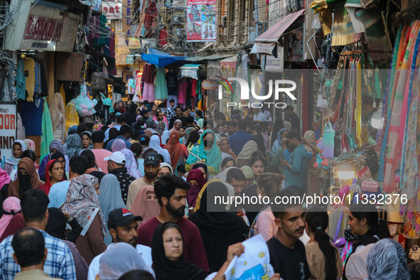 People are shopping at a market ahead of the Eid al-Adha festival in Srinagar, India, on June 15, 2024. Eid al-Adha is the holiest of the tw...