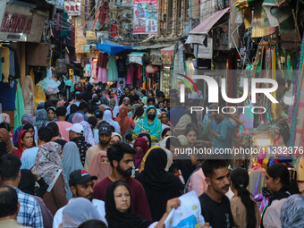 People are shopping at a market ahead of the Eid al-Adha festival in Srinagar, India, on June 15, 2024. Eid al-Adha is the holiest of the tw...