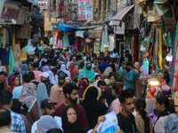 People are shopping at a market ahead of the Eid al-Adha festival in Srinagar, India, on June 15, 2024. Eid al-Adha is the holiest of the tw...