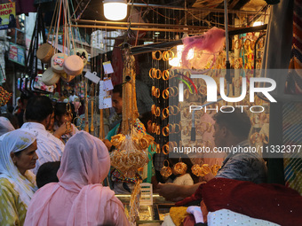 Women are shopping at a jewellery store ahead of the Eid al-Adha festival in Srinagar, India, on June 15, 2024. Eid al-Adha is the holiest o...