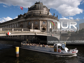 A boat with tourists is passing in front of Bode Museum on the Spree River in Berlin, Germany, on June 15, 2024. (