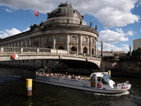 A boat with tourists is passing in front of Bode Museum on the Spree River in Berlin, Germany, on June 15, 2024. (