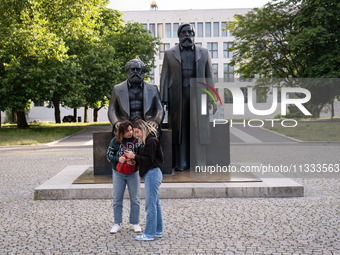 People are taking photos in front of the Marx and Engels monument in Berlin, Germany, on June 15, 2024. (