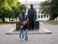 People are taking photos in front of the Marx and Engels monument in Berlin, Germany, on June 15, 2024. (