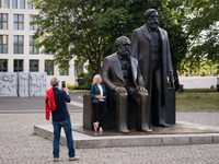 People are taking photos in front of the Marx and Engels monument in Berlin, Germany, on June 15, 2024. (