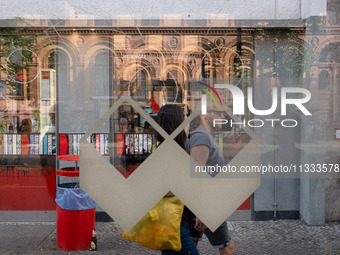 A man is passing behind a bus station in Berlin, Germany, on June 15, 2024. (