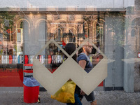 A man is passing behind a bus station in Berlin, Germany, on June 15, 2024. (