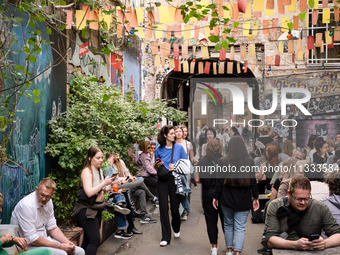 People are enjoying their time at a coffee shop in Kino Central in Berlin, Germany, on June 15, 2024. (