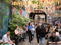 People are enjoying their time at a coffee shop in Kino Central in Berlin, Germany, on June 15, 2024. (