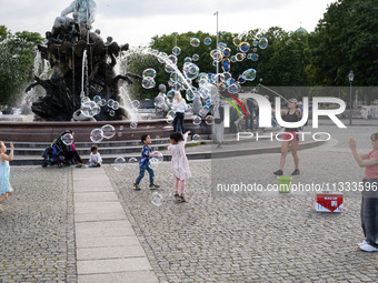 People are enjoying their time at Neptune Fountain in Berlin, Germany, on June 15, 2024. (