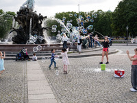 People are enjoying their time at Neptune Fountain in Berlin, Germany, on June 15, 2024. (