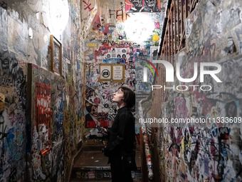 A woman is looking at a wall full of stickers at Kino Central in Berlin, Germany, on June 15, 2024. (