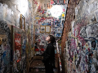 A woman is looking at a wall full of stickers at Kino Central in Berlin, Germany, on June 15, 2024. (