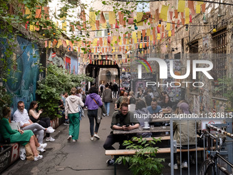 People are enjoying their time at a coffee shop in Kino Central in Berlin, Germany, on June 15, 2024. (