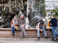 People are enjoying their time at Neptune Fountain in Berlin, Germany, on June 15, 2024. (