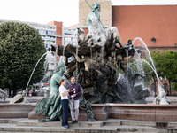 People are enjoying their time at Neptune Fountain in Berlin, Germany, on June 15, 2024. (