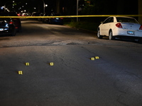 Evidence markers placed at the crime scene where shell casings were located as a Rideshare driver was shot and carjacked in Chicago, Illinoi...