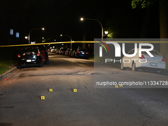 Evidence markers placed at the crime scene where shell casings were located as a Rideshare driver was shot and carjacked in Chicago, Illinoi...