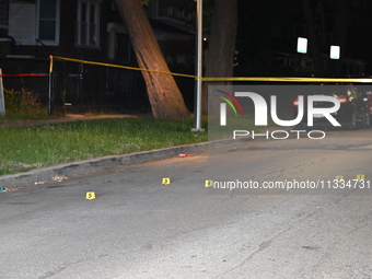 Evidence markers placed at the crime scene where shell casings were located as a Rideshare driver was shot and carjacked in Chicago, Illinoi...