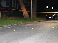 Evidence markers placed at the crime scene where shell casings were located as a Rideshare driver was shot and carjacked in Chicago, Illinoi...