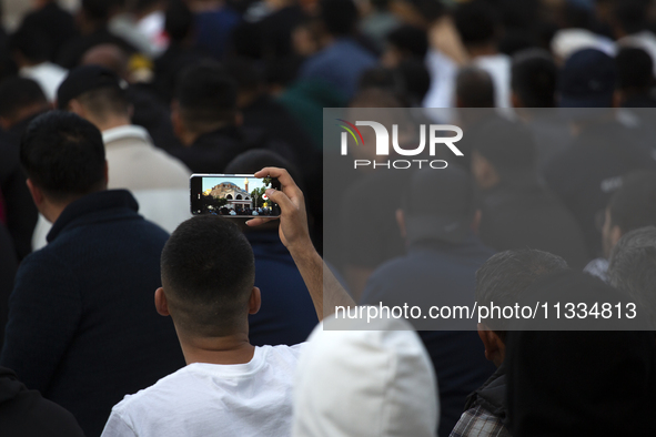 Muslims are praying in front of the Central Mosque of Sofia - Banya Bashi Mosque, marking and celebrating the holiday of Eid al Adha in Sofi...