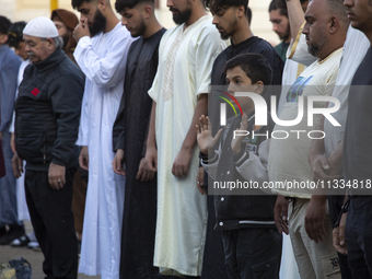 Muslims are praying in front of the Central Mosque of Sofia - Banya Bashi Mosque, marking and celebrating the holiday of Eid al Adha in Sofi...