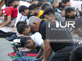 Muslims are praying in front of the Central Mosque of Sofia - Banya Bashi Mosque, marking and celebrating the holiday of Eid al Adha in Sofi...