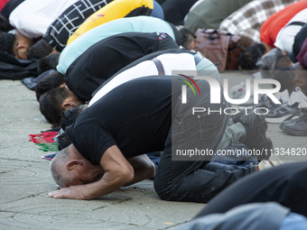 Muslims are praying in front of the Central Mosque of Sofia - Banya Bashi Mosque, marking and celebrating the holiday of Eid al Adha in Sofi...