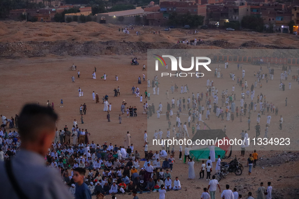 People are gathering to perform Eid prayers on one of the hills in the village of Abu Sir, in the middle of some of the ancient archaeologic...