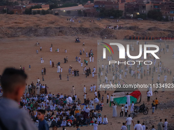 People are gathering to perform Eid prayers on one of the hills in the village of Abu Sir, in the middle of some of the ancient archaeologic...