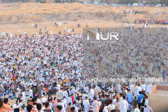 People are gathering to perform Eid prayers on one of the hills in the village of Abu Sir, in the middle of some of the ancient archaeologic...