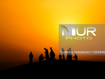 People are gathering to perform Eid prayers on one of the hills in the village of Abu Sir, in the middle of some of the ancient archaeologic...