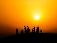 People are gathering to perform Eid prayers on one of the hills in the village of Abu Sir, in the middle of some of the ancient archaeologic...