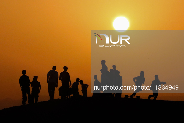 People are gathering to perform Eid prayers on one of the hills in the village of Abu Sir, in the middle of some of the ancient archaeologic...