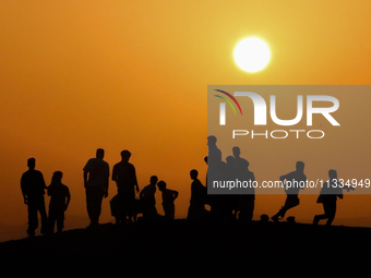 People are gathering to perform Eid prayers on one of the hills in the village of Abu Sir, in the middle of some of the ancient archaeologic...